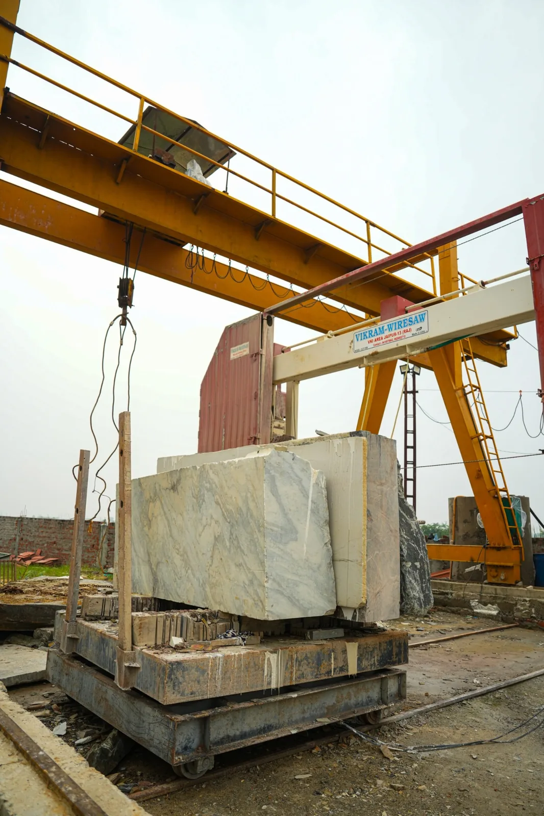 Natural stone block being processed with a large stone cutting machine