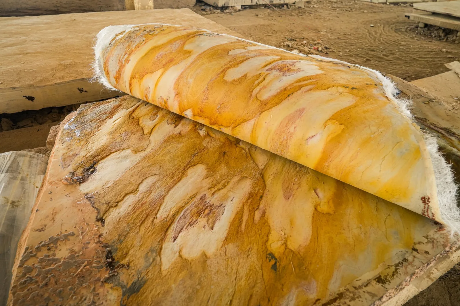 Close view of richly coloured natural stone with warm golden and earth tones