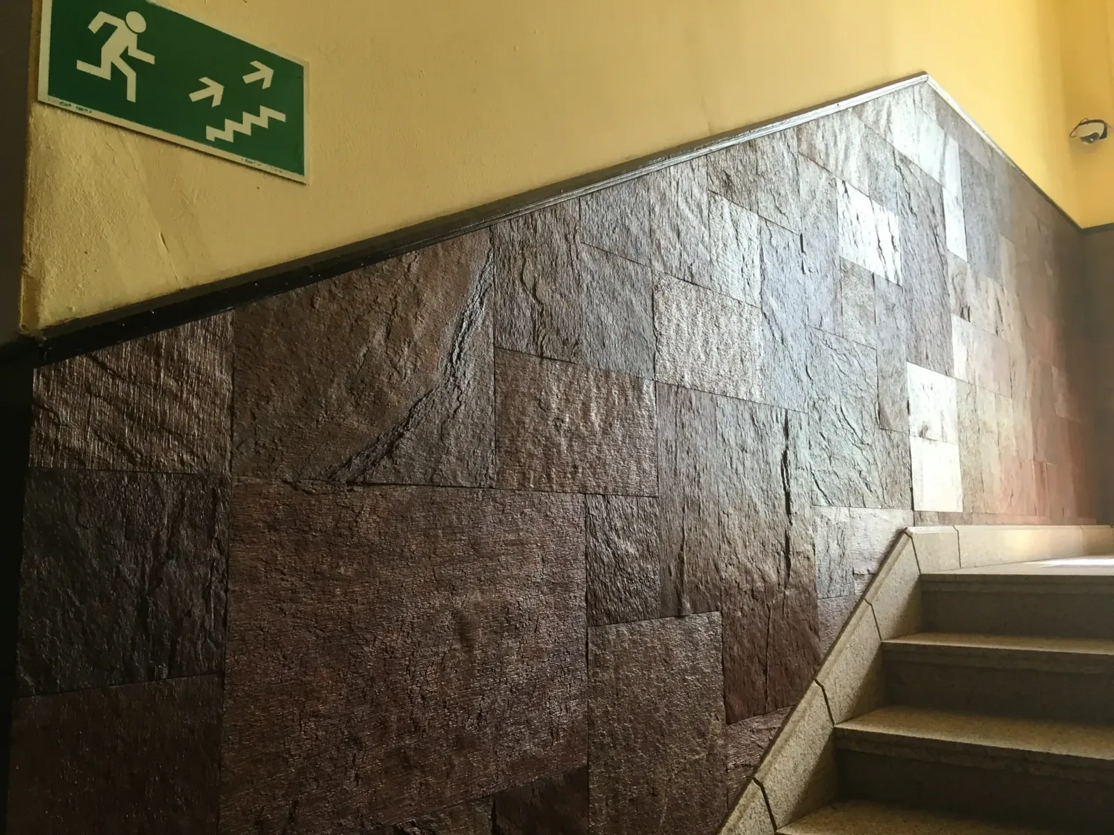 Natural stone wall veneer beside a staircase